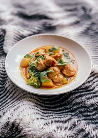 white bowl of chicken and vegetable thai curry