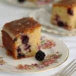 slices of blackberry and lemon drizzle cake on plates
