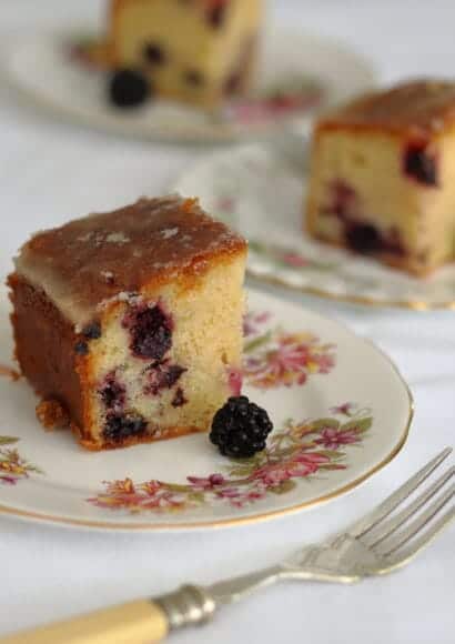 slices of blackberry and lemon drizzle cake on plates
