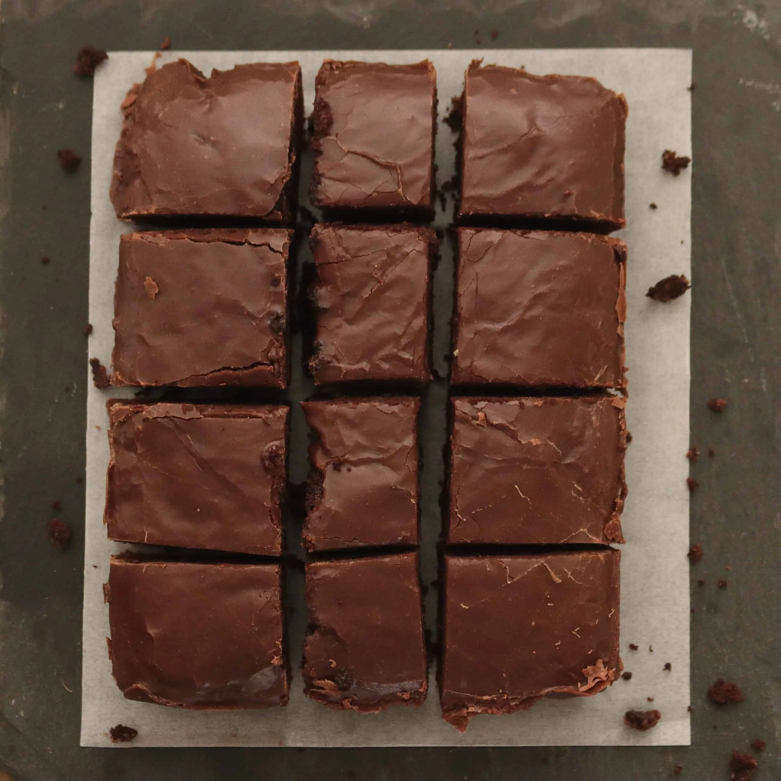 Chocolate Fudge cake on paper cut into squares