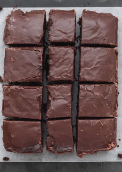 Chocolate fudge cake on paper cut into squares