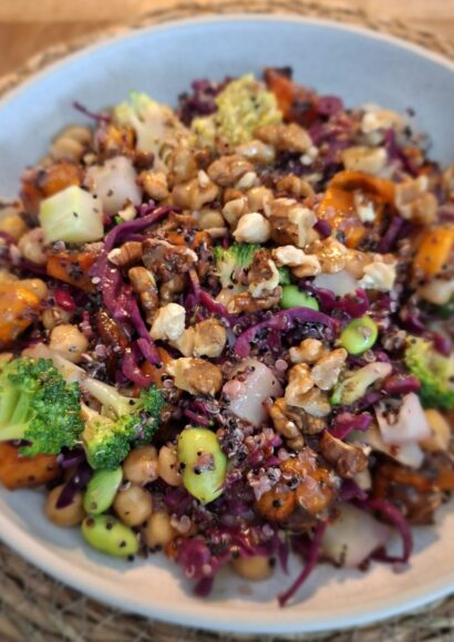 plant-protein lunchtime bowl your way - a bowl of colourful vegetables, nuts, chickpeas and dressing on the table
